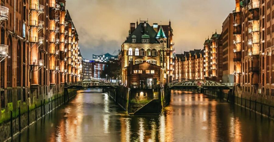 Speicherstadt warehouses floodlit above the canal after dark